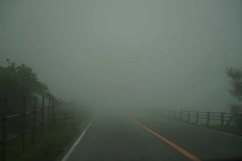 View of foggy roadway and fence while driving through local road | Marietta Wrecker Foggy Road Fall Safety Tips | Marietta Wrecker Service
