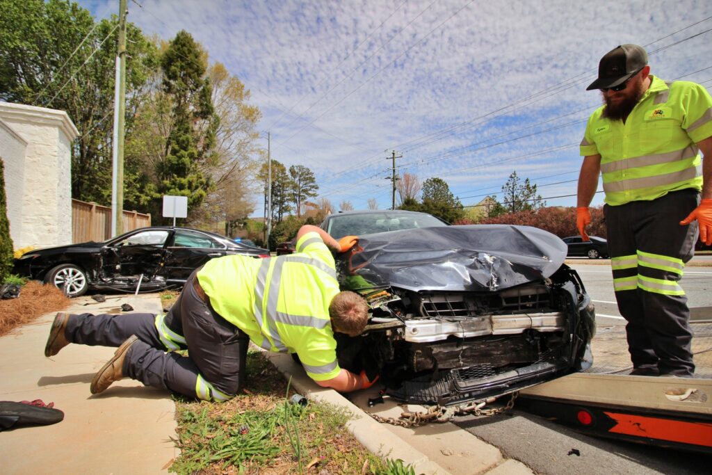Workers Inspecting Wrecked Vehicle | Marietta Wrecker