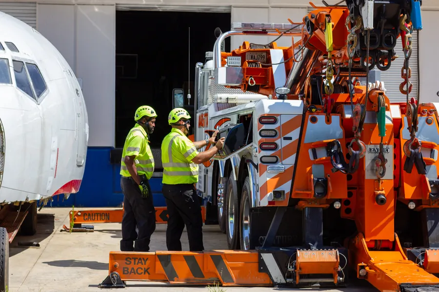 Workers loading truck | Marietta Wrecker